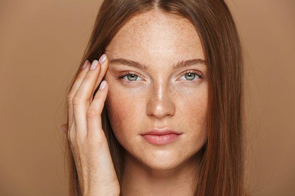 Women with smooth skin, silk ginger hair and subtle makeup on