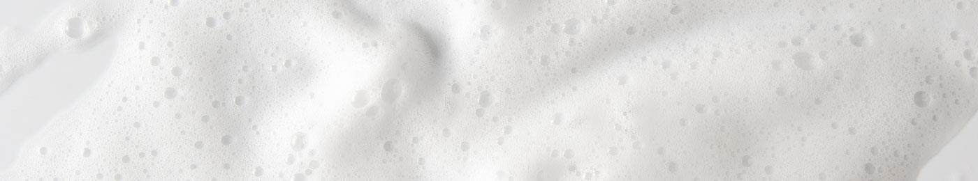 Extreme close-up on foaming white bubbles